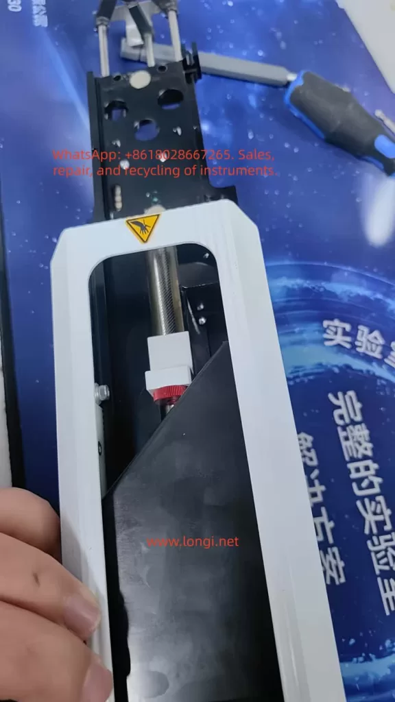 CTC autosampler injector Z-axis carriage with lead screw nut, needle holder, and mechanical guide rails during maintenance