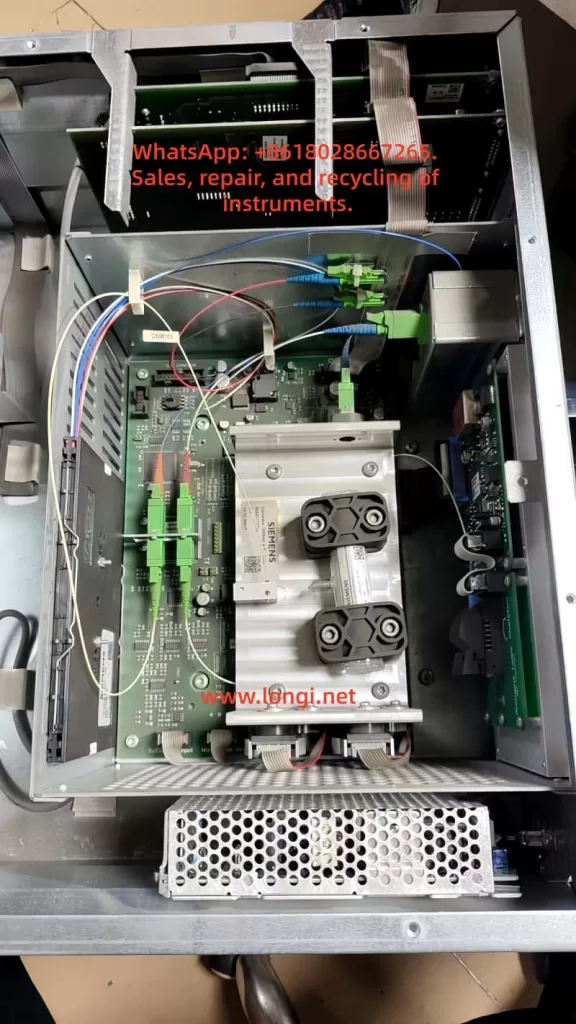 Internal view of Siemens LDS 6 ammonia analyzer central unit with optical modules, circuit boards, fiber connections, and power supply exposed