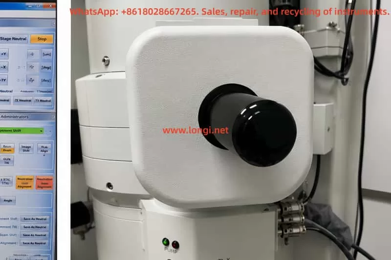 Close-up external view of the JEOL JEM-1400 electron gun filament housing and electron source assembly mounted on the TEM column in a laboratory environment.