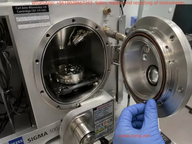 Technician inspecting the open ZEISS Sigma 300 SEM sample chamber, chamber door seal, O-ring, and sample stage during vacuum leakage and pump-down troubleshooting.