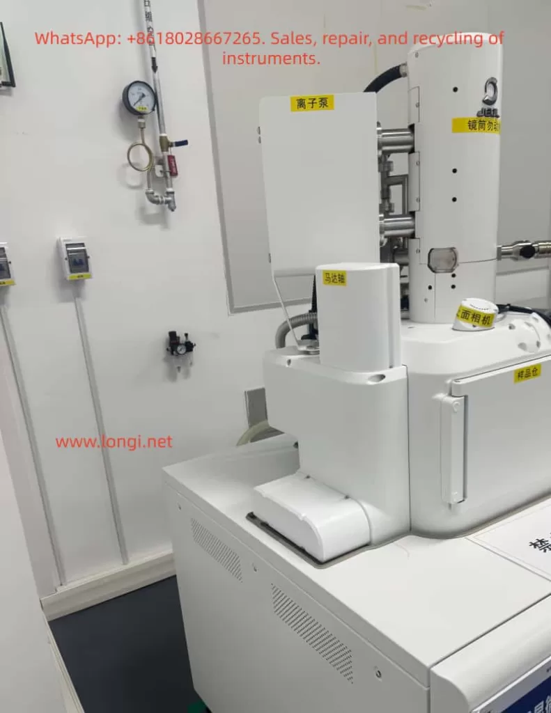 JEOL JSM-IT700HR/LA field emission scanning electron microscope side view showing the electron column, ion pump, sample chamber, camera module, and laboratory gas pressure gauge.