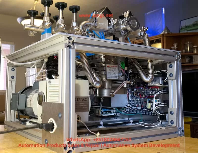 Open-frame laboratory vacuum system with Edwards mechanical vacuum pump, Trivac pump assembly, stainless steel bellows, pneumatic valves, wiring terminals, and vacuum chamber piping.