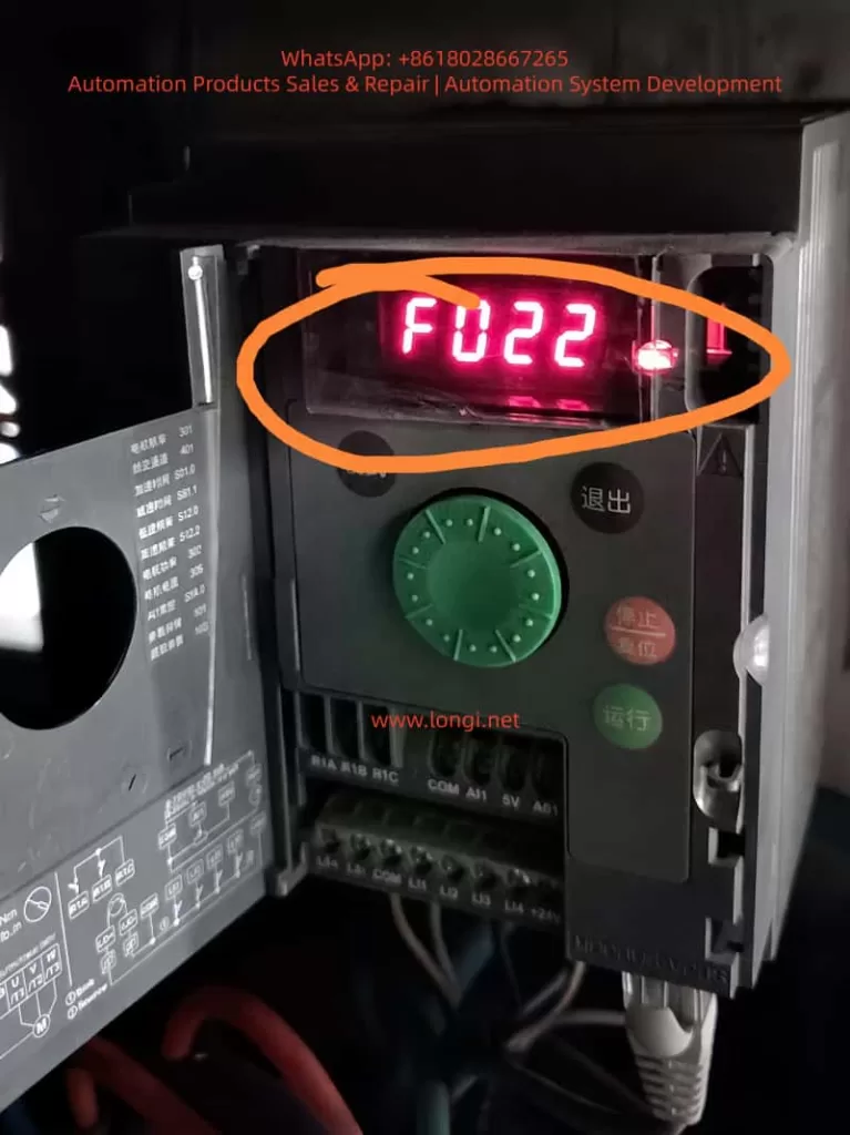 Schneider ATV310 variable frequency drive inside an electrical cabinet, with the front cover open and the red LED display showing F022 Modbus communication fault.
