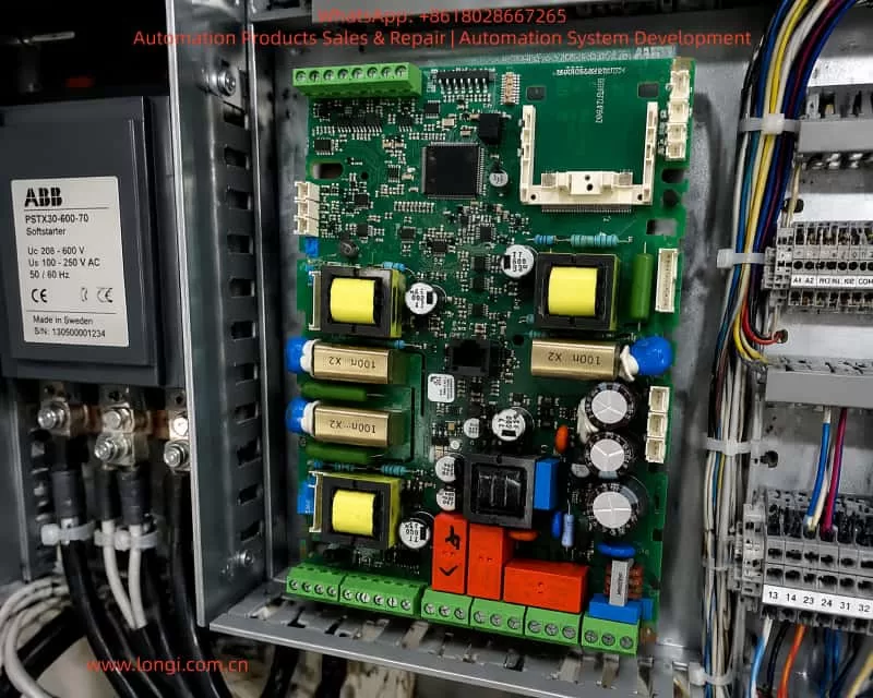 ABB PSTX soft starter power supply board installed inside an industrial control cabinet, showing PCB components, wiring terminals, and electrical connections for motor control applications.